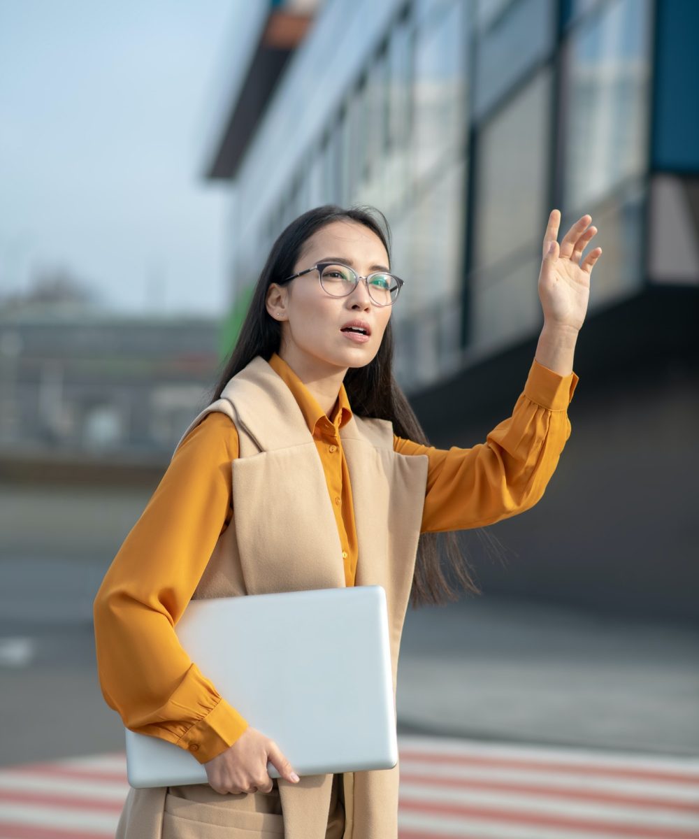 young-asian-pretty-woman-waving-her-hand-on-the-road.jpg